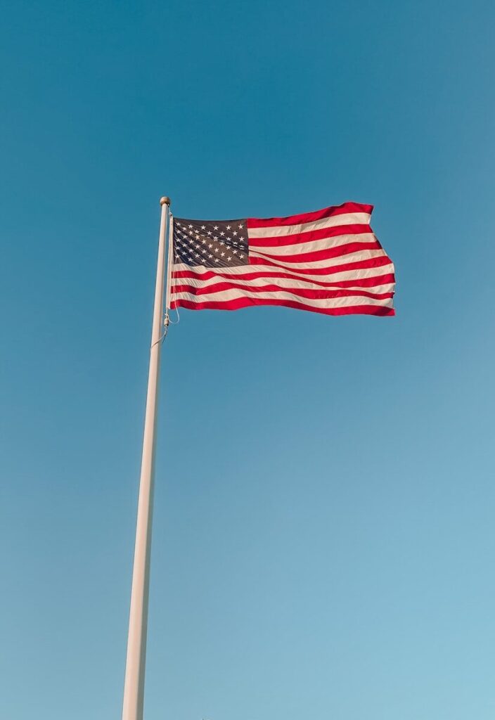 the american flag is flying high in the sky