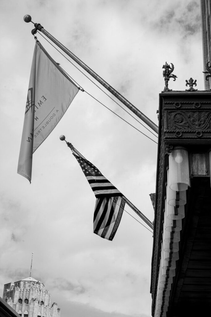 USA Transportation Guide: A Complete Beginner’s Handbook (2026) A black and white photo of two american flags