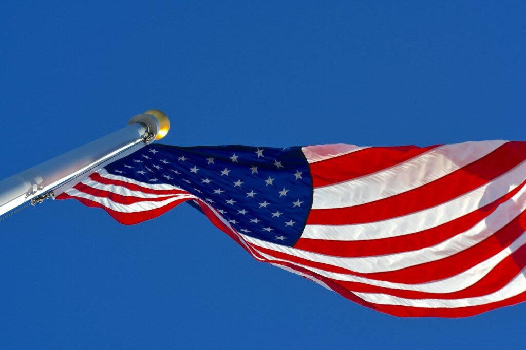 us a flag under blue sky during daytime