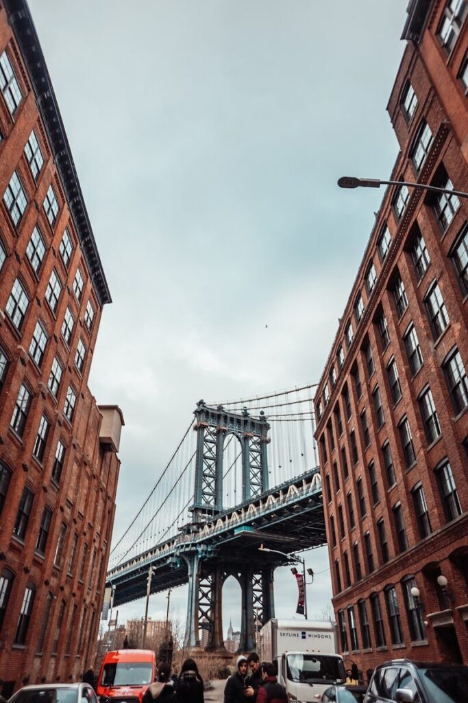 Major Attractions of North America brown concrete building near bridge under white clouds during daytime